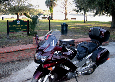 Motorcycle parked in front of lakeside park (c) 2010 Ted Grellner